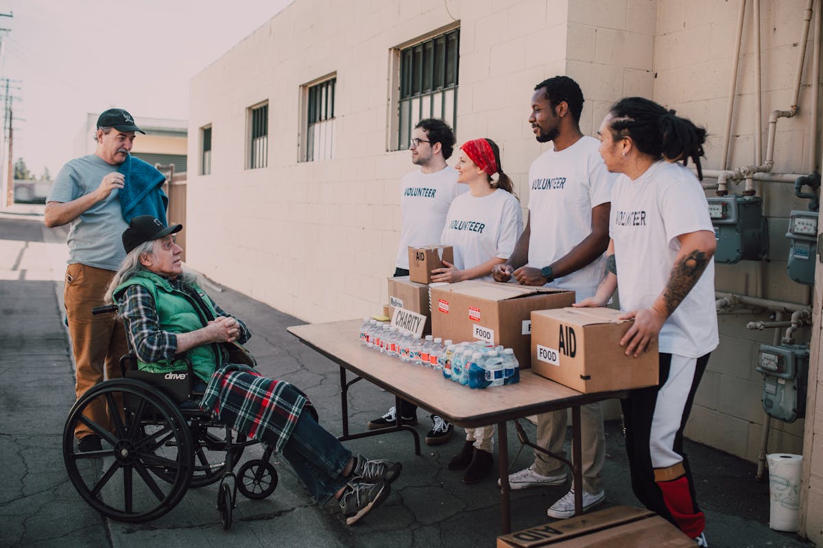 Volunteers organizing food aid for elderly community member