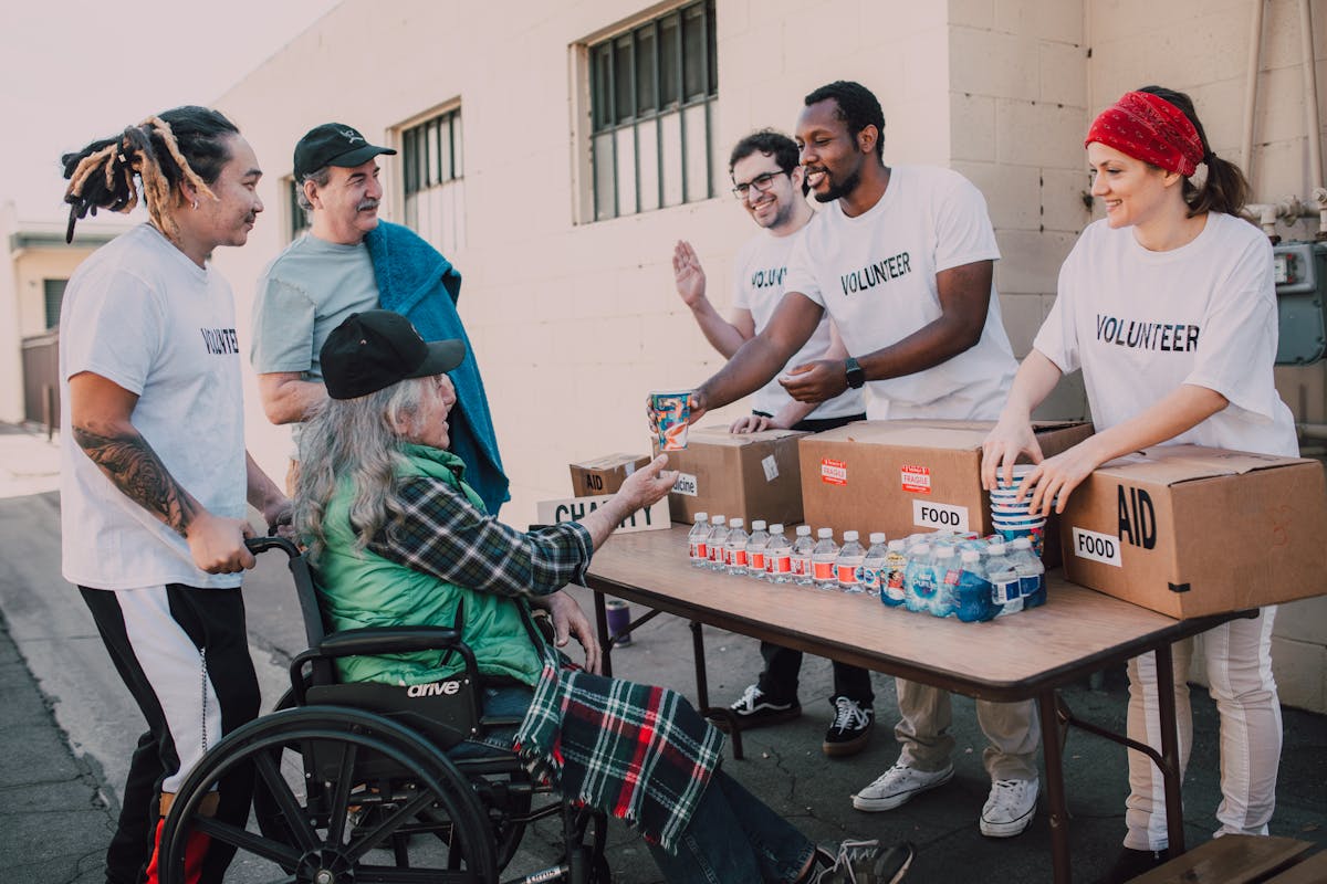 Volunteers distributing food aid and water to community members